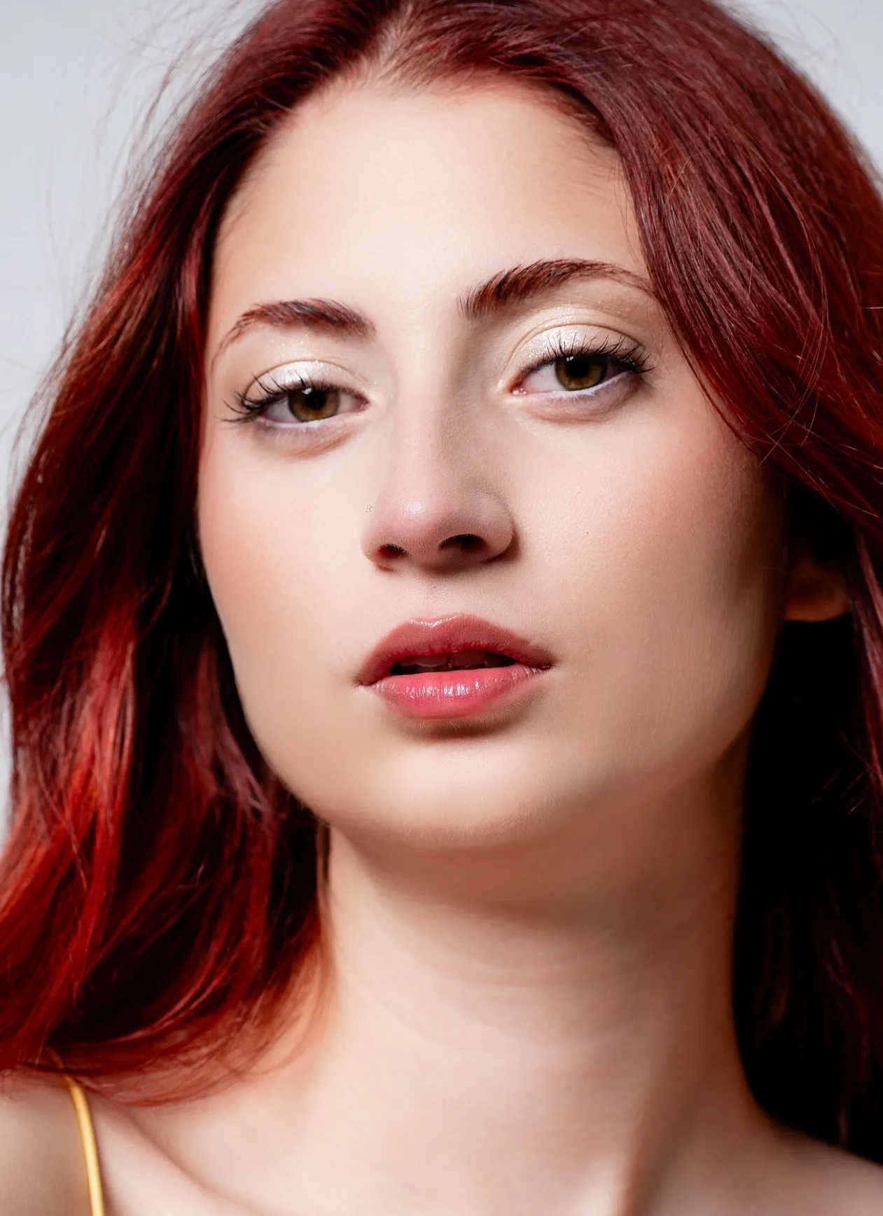 Clean beauty look with bare luminous skin, brushed-up brows and a sheer glossy lip.